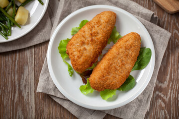 Breaded Fish Fillet With Salad. High quality photo.