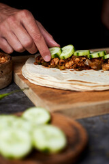 Poster - young man is filling a durum or a burrito