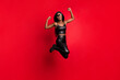 © deagreez - Full length body size view of cheerful cool lucky girl wear leather suit jumping rejoicing isolated on bright red color background