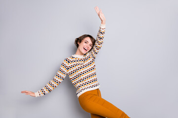 Portrait of pretty cheerful girl dancing having fun rest relax isolated over grey pastel color background