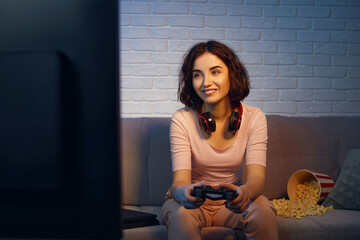 involved gamer girl playing video games on the console