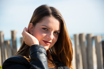 Smiling caucasian young woman with long hair outdoors