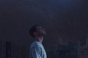 man watching the night sky, looking up, stars of milky way galaxy. elements of this image furnished by nasa