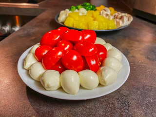 Wall Mural - Plate with tomatoes and mozzarella.