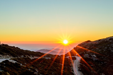  Beautiful Sunset over the Mountains of Crete Island, Greece. Panoramic View from a Mountain Top with a Dirt Road. Golden Sun Rays.