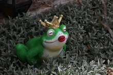 Decorative Frog Princess Among Plants In The Garden