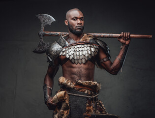 Wall Mural - Warlike african man with axe wearing ancient fur and armour