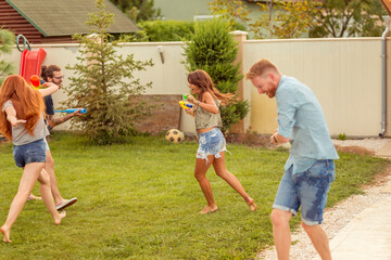 Friends playing with squirt guns