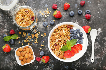 Poster - Tasty granola with fresh berries on grey background