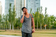 © Spectral-Design - Young asian guy talking on the phone in a park