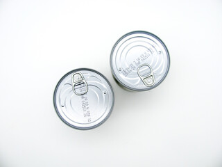 Two tin closed cans on a white background. Top view.