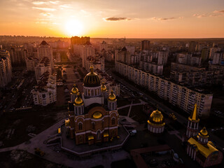 Wall Mural - Aerial view from a drone to the sunset over the city of Kiev on Obolon embankment