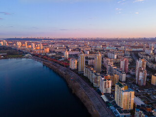 Wall Mural - Aerial view from a drone to the sunset over the city of Kiev on Obolon embankment
