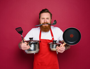 Wall Mural - Chef hold a lot of pots. concept of stress and confusion. red background