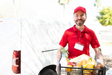 Wall Mural - Delivery man delivering fruits and vegetables from the market