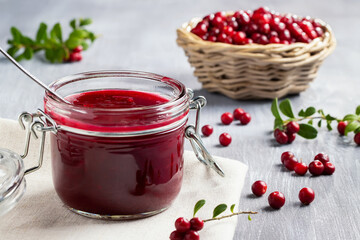 Glass jar with homemade lingonberry sauce. Canning lingonberry sauce