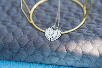 Canvas Print - Best friends heart two parts necklace shoot outside in a summer day closeup. Selective Focus. High quality photo