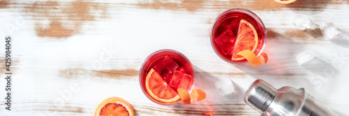 Obraz Dibond Negroni cocktails panorama with blood oranges and a place for text or logo