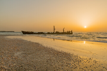 Sticker - Sunset view of a rusty shipwreck in HaBonim Beach