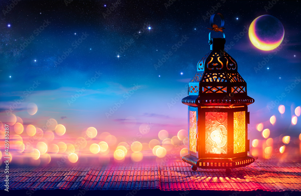 Muslim Holy Month Ramadan Kareem - Arabic Lantern With Burning Candle And Bokeh Glowing At Evening - Eid Ul Fitr - obrazy, fototapety, plakaty 