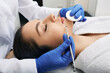 © Peakstock - Facial cleansing. Beautiful woman having mechanical cleansing face skin from defect and remove blackhead
