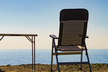 Wall Mural - Tourist table and chair on coast