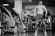 © AS Photo Family - Fit and muscular arabian man doing workouts in gym.
