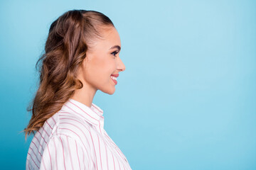 Side profile photo portrait cute nice pretty female student smiling looking blank space isolated vivid blue color background