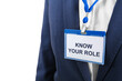 © New Africa - Office worker wearing badge with phrase Know Your Role, closeup. Corporate social responsibility