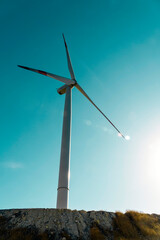 Natural power supply concept: Wind turbines against blue sky. Windmill technology for environmental conservation and climate change. Electricity source. Renewable energy.