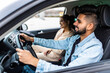 © F8  \ Suport Ukraine - leisure, road trip, travel, family and people concept. Young happy indian man and woman driving in car