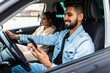 © F8  \ Suport Ukraine - Traveler young indian couple use smart phone while driving car