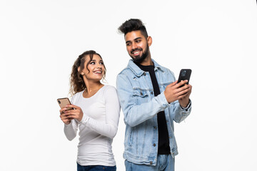 Portrait of attractive indian couple holding in phone, girl worrying looking at guy's chat isolated over white background