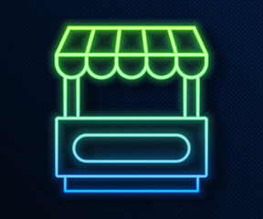 Canvas Print - Glowing neon line Fast street food cart with awning icon isolated on blue background. Urban kiosk. Vector