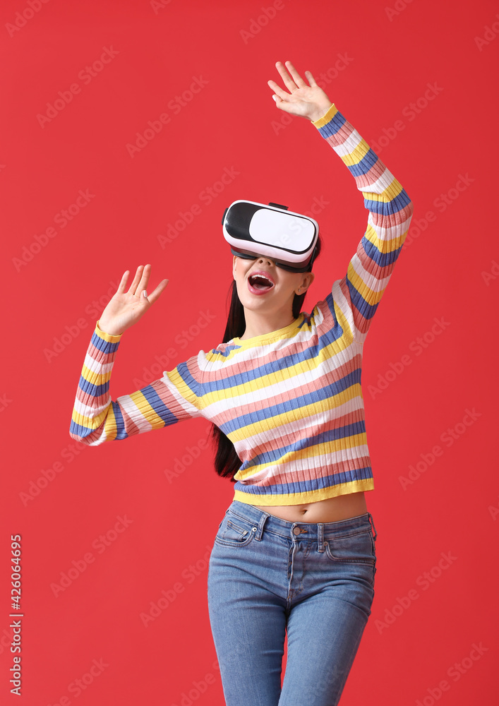 Young woman with VR glasses on color background - obrazy, fototapety, plakaty 