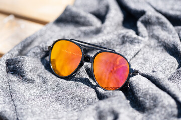 Wall Mural - Sunglasses aviator design with big lenses shoot outside in a summer day closeup . Selective focus. High quality photo