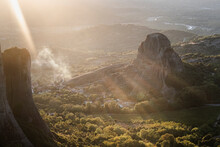 Sunset light and sun beams in the smoke in Meteora, Thessaly, Greece