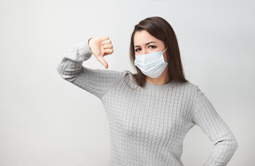 Wall Mural - Young woman wearing medical mask, white background.