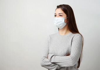 Poster - Young woman wearing medical mask, white background.