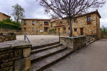 Old houses in a square in a town in the Sierra de Madrid. Horcajuelo.