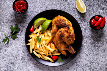 Wall Mural - Half roasted chicken Piri Piri with french fries