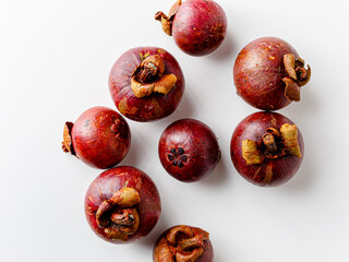 Mangosteens isolated on white background. Tropical fruits.