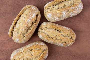 Wall Mural - Fresh rolls lying on a wooden table. Crispy bread.