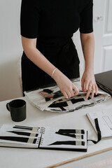 Wall Mural - Vertical shot of a young female fashion designer working in her workshop