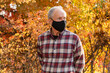 © Tetra Images - Senior man wearing protective mask in autumn park