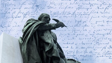 Bronze Memorial Statue Of William Shakespeare, Who Stands With Pen In Hand. The Sky And His Writings In The Background.