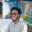 © Tetra Images - Black man in sunglasses smiling
