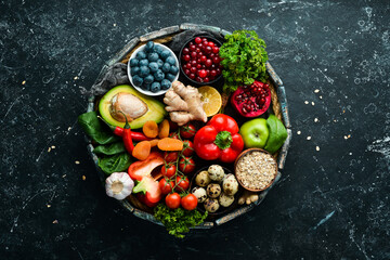 Wall Mural - Healthy food for the heart. Dietary food. On a black stone background. Top view. Free copy space.