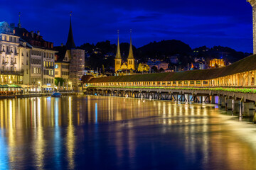 Night view towards Chapel Bridge (Kapellbruecke) together with the octagonal tall tower (Wasserturm) it is one of the Lucerne's most famous tourists attraction