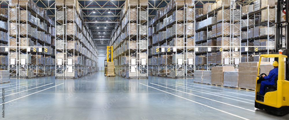 Huge distribution warehouse with high shelves and forklift with driver. - obrazy, fototapety, plakaty 